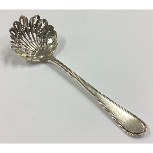 27 - A Victorian silver sifter spoon with bead pattern decoration. Sheffield 1875. By Martin Hall & Co. A... 