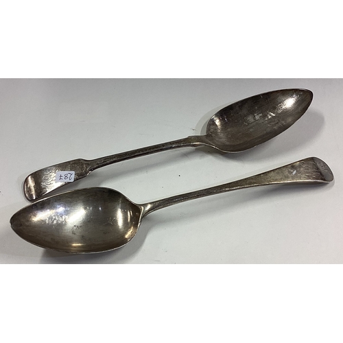 287 - EXETER: A Georgian silver table spoon together with one other. Approx. 129 grams. Est. £30 - £50.