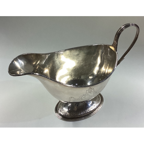 298 - HESTER BATEMAN: A rare large and oversized 18th Century silver sauceboat with crested decoration to ... 