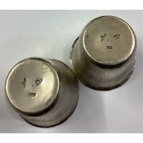 322 - A pair of Continental silver stacking shot cups with hammered decoration. Approx. 52 grams. Est. £40... 