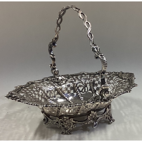 338 - A good Georgian silver swing handled sugar basket on chased feet. London. Approx. 185 grams. Est. £1... 