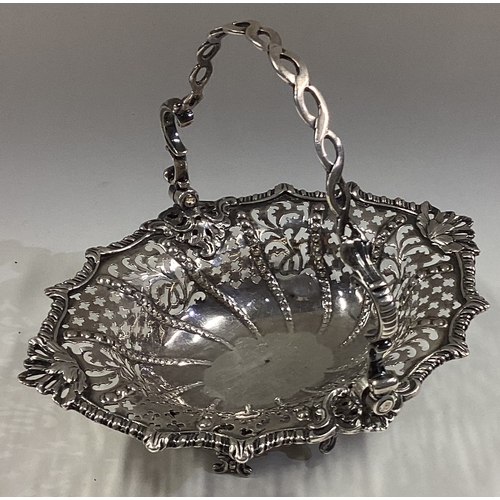 338 - A good Georgian silver swing handled sugar basket on chased feet. London. Approx. 185 grams. Est. £1... 