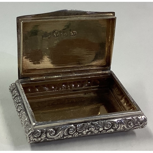 362 - A Victorian silver snuff box with chased decoration. Birmingham. By TS. Approx. 41 grams. Est. £100 ... 