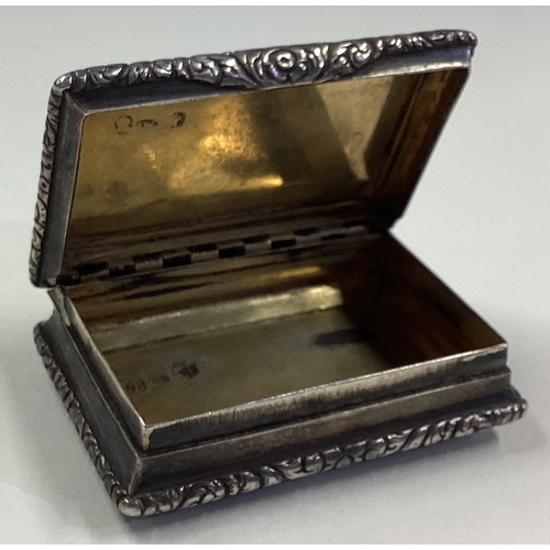 363 - A Georgian silver snuff box with hinged lid to chased sides. By JW. Approx. 81 grams. Est. £100 - £1... 