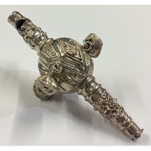 40 - A silver baby's rattle with chased decoration. Circa 1900. Approx. 27 grams. Est. £30 - £40.