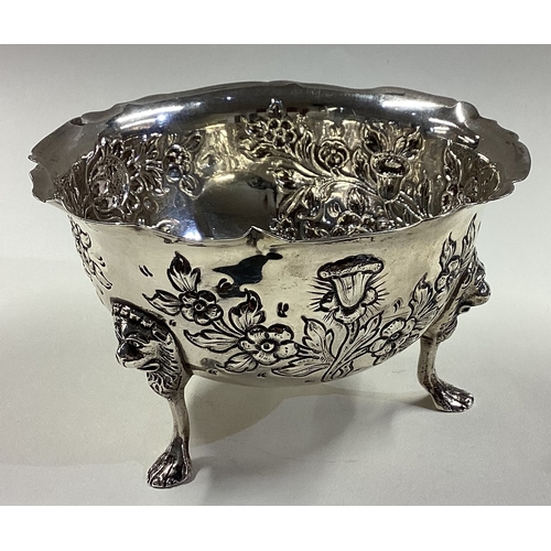 417 - DUBLIN: A clean Irish silver bowl with embossed decoration and lion mask feet. 1929. By West & Son. ... 