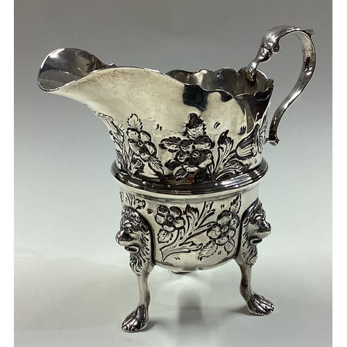 418 - DUBLIN: A clean Irish silver jug with embossed decoration. 1929. By West & Son. Approx. 153 grams. E... 