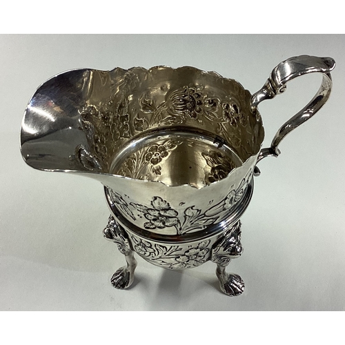 418 - DUBLIN: A clean Irish silver jug with embossed decoration. 1929. By West & Son. Approx. 153 grams. E... 