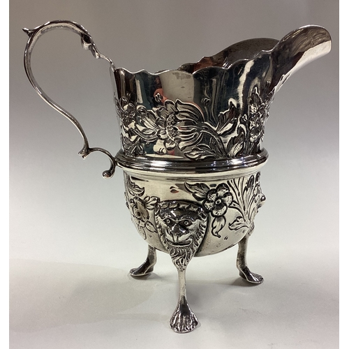 418 - DUBLIN: A clean Irish silver jug with embossed decoration. 1929. By West & Son. Approx. 153 grams. E... 