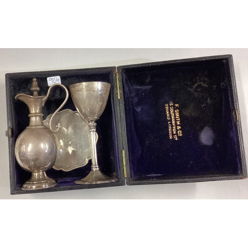 426 - A boxed silver three-piece communion set. London. By JE. Approx. 140 grams. Est. £60 - £80.