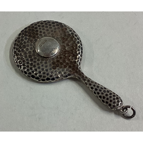 429 - A miniature silver hand mirror with hammered decoration. Birmingham 1905. Approx. 10 grams. Est. £25... 