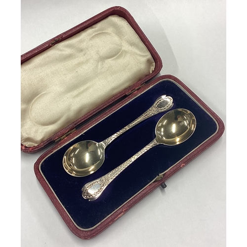 44 - A good boxed pair of silver gilt preserve spoons in the Georgian style. Sheffield. By CW. Approx. 32... 