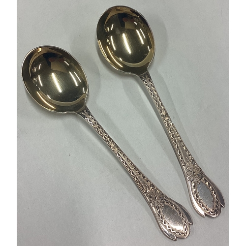 44 - A good boxed pair of silver gilt preserve spoons in the Georgian style. Sheffield. By CW. Approx. 32... 