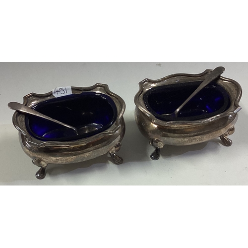 451 - A good pair of silver salts together with matching spoons. Approx. 102 grams. Est. £30 - £50.