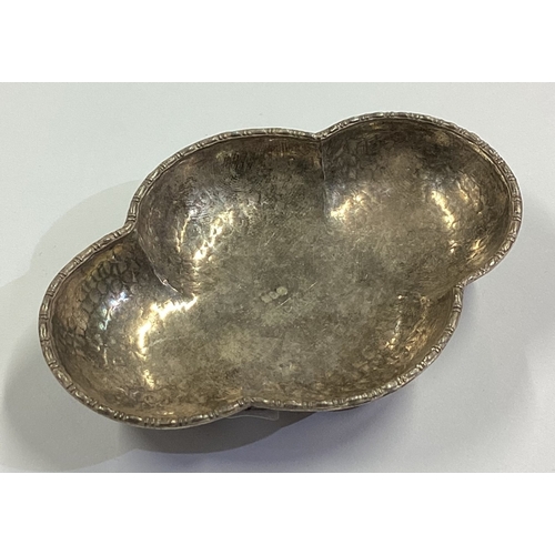 48 - An Arts and Craft Continental silver dish on feet with hammered decoration. Approx. 18 grams. Est. £... 