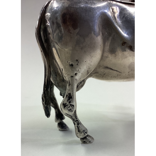 529 - A Naturalistic Continental silver cow creamer with hinged cover. Circa 1900. Approx. 93 grams. Est. ... 