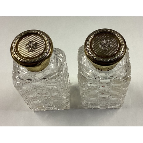 531 - A large pair of silver gilt and glass scent bottles with screw-top lids. London 1908. By John Vicker... 