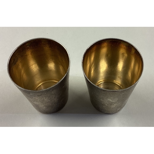 533 - A pair of Continental silver stacking beakers. Marked to bases. Approx. 42 grams. Est. £40 - £60.