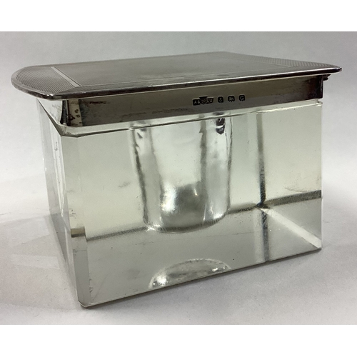 546 - ASPREY & CO: A large and heavy hinged silver lidded inkwell. Birmingham 1931. Est. £150 - £200.