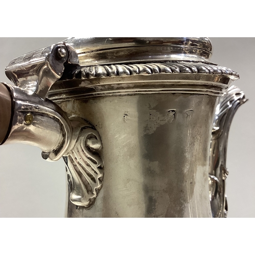 63 - A large George III silver coffee pot with central armorial. London 1764. Approx. 934 grams. Est. £70... 