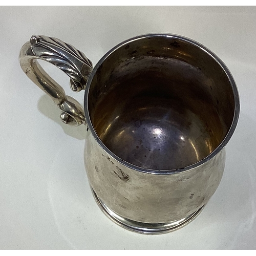 657 - A small baluster shaped silver mug on spreading foot. Approx. London. By WL. Approx. 200 grams. Est.... 