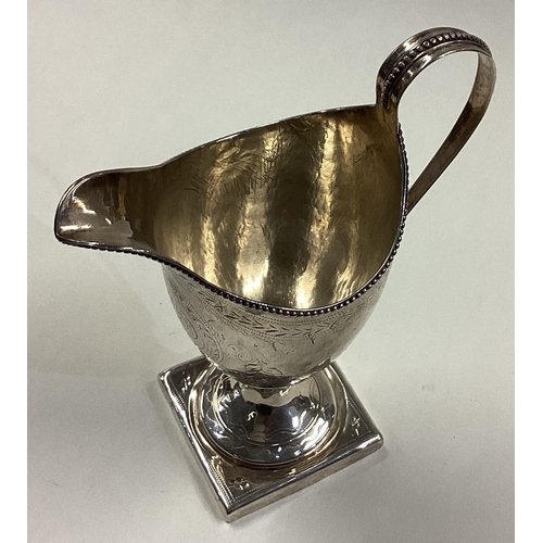 67 - An 18th Century George III silver cream jug with bright-cut decoration. London 1789. By George Green... 