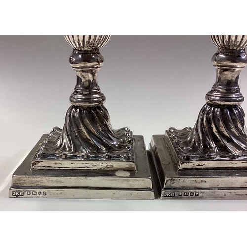 68 - A fine pair of Victorian silver candlesticks with fluted decoration. Sheffield 1888. By JKB. Approx.... 