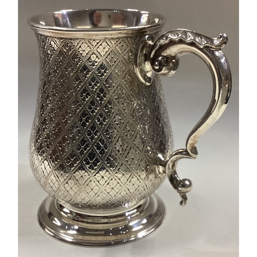 681 - A good quality baluster shaped Victorian silver mug attractively decorated with flowers. London. By ... 