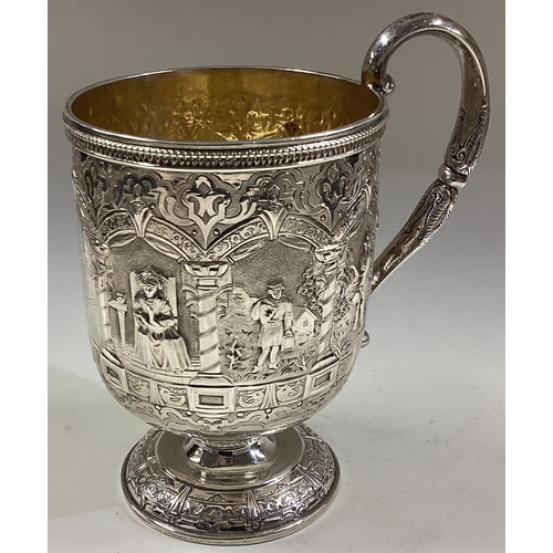 694 - A fine quality Victorian silver christening cup attractively decorated with figures to gilt interior... 