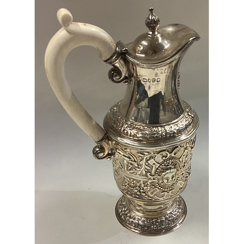 695 - A heavy bachelor's silver ewer chased with birds and animals. London. By JM Ltd. Approx. 334 grams. ... 