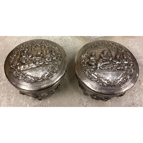 78 - A fine pair of large 19th Century Burmese silver betel boxes and covers with fine Naturalistic chase... 