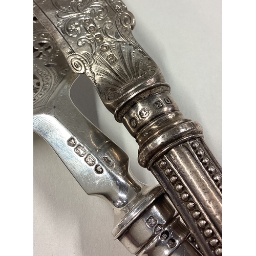 83 - A matched pair of Victorian silver servers engraved with fish decoration. Approx. 264 grams grams of... 