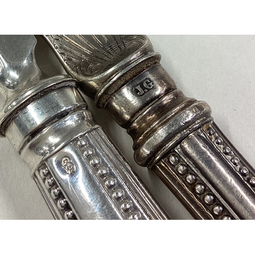 83 - A matched pair of Victorian silver servers engraved with fish decoration. Approx. 264 grams grams of... 