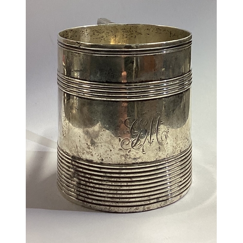 91 - A Georgian silver mug with reeded decoration. London 1791. By TD. Approx. 100 grams. Est. £100 - £15... 