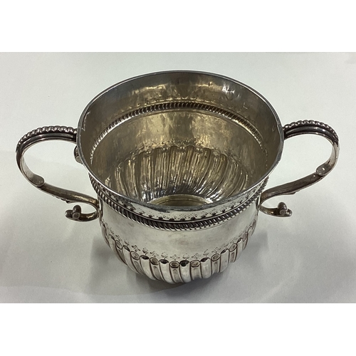 99 - An 18th Century Queen Anne silver porringer. London 1704. Approx. 193 grams. Est. £600 - £800.