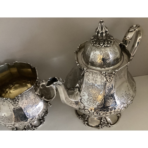 699 - EXETER: A fine quality large silver four-piece tea and coffee service with panelled body profusely d... 