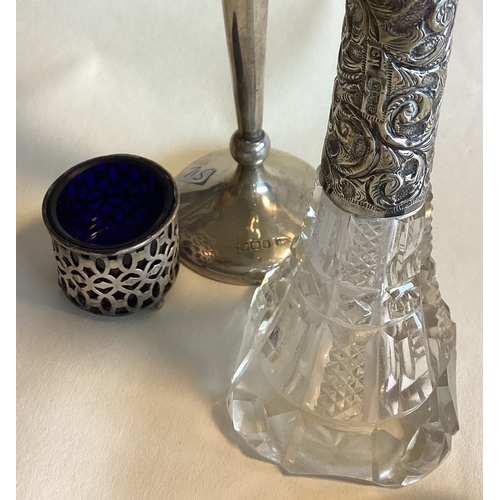 715 - A pair of silver mounted salts together with a spill vase etc. Est. £20 - £30.