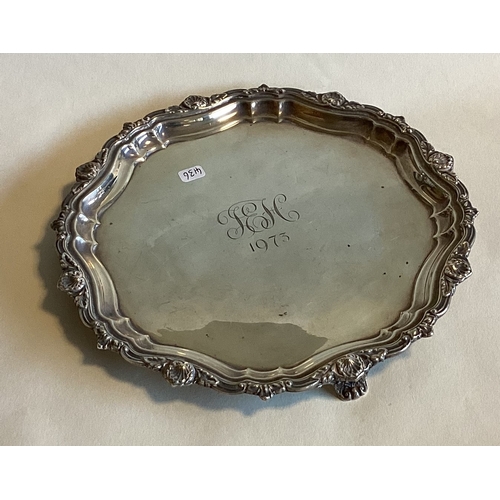 716 - A circular silver waiter with shell border. Birmingham. Approx. 308  grams. Est. £100 - £150.