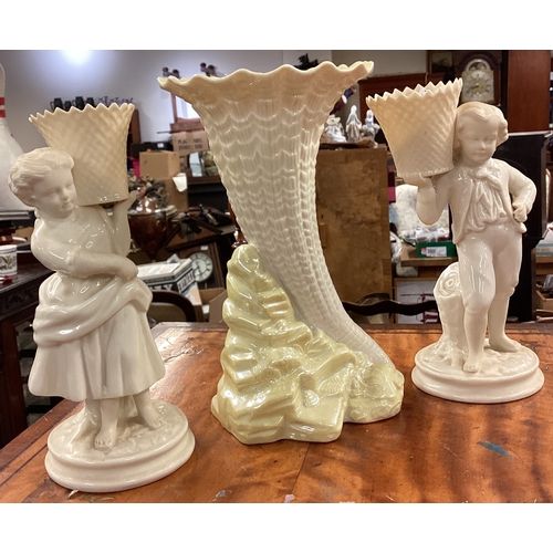 235 - A pair of Belleek vases decorated with children together with one other. Est. £30 - £50.