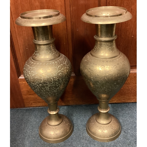 326 - A large pair of engraved brass vases. Est. £20 - £30.