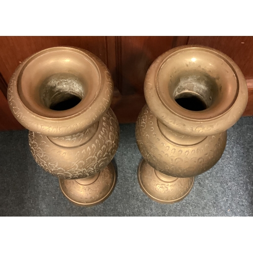 326 - A large pair of engraved brass vases. Est. £20 - £30.