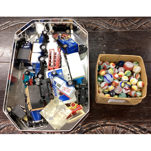 331 - A good collection of old glass marbles together with toy model vehicles. Est. £20 - £30.