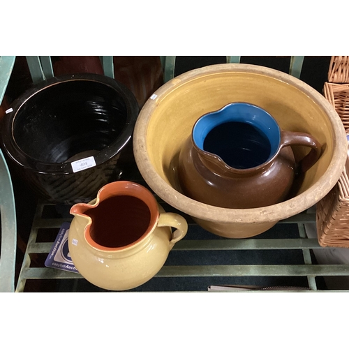 404 - A group of pottery jugs and bowls. Est. £20 - £30.