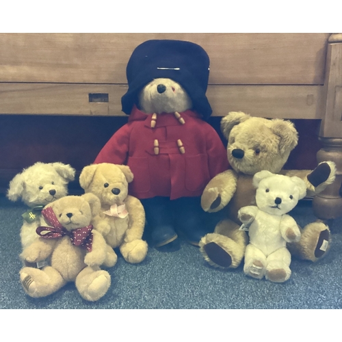 450 - An old Paddington bear together with a Harrods bear and other teddies. Est. £30 - £50.