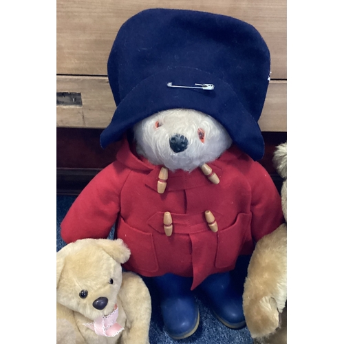 450 - An old Paddington bear together with a Harrods bear and other teddies. Est. £30 - £50.