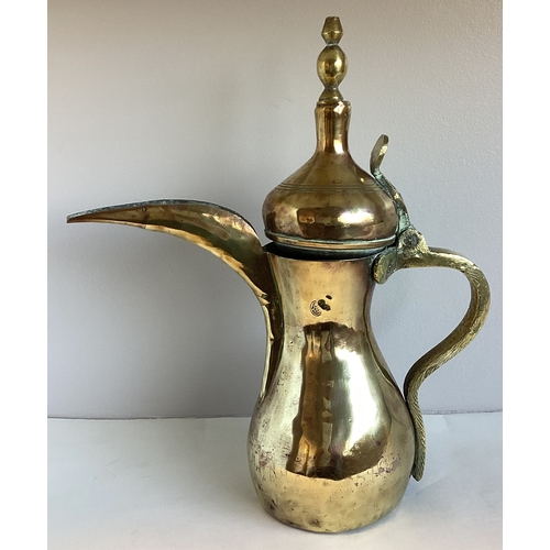 458 - An old Indian brass ewer. 31 cms high. Est. £10 - £15.