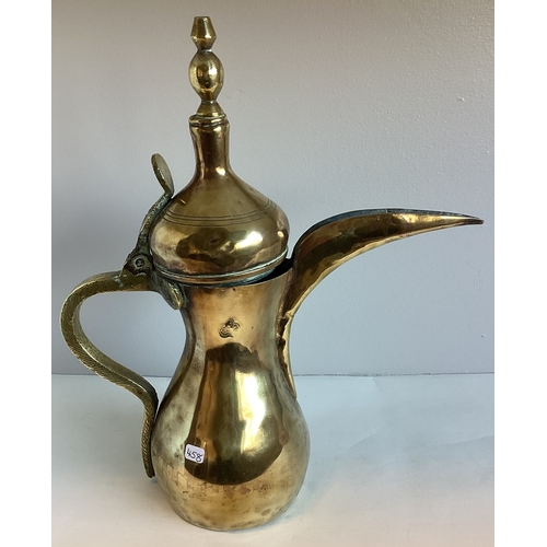 458 - An old Indian brass ewer. 31 cms high. Est. £10 - £15.