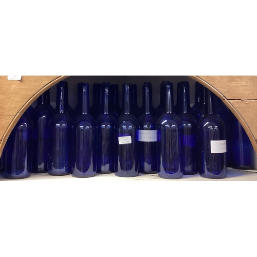 461 - A large collection of blue glass wine bottles. Est. £20 - £30.