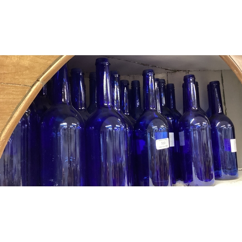 461 - A large collection of blue glass wine bottles. Est. £20 - £30.