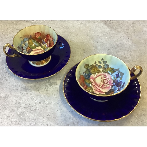 467 - A pair of Cobalt Blue Aynsley bone china teacups and saucers in Cabbage Rose pattern. Signed J A Bai... 